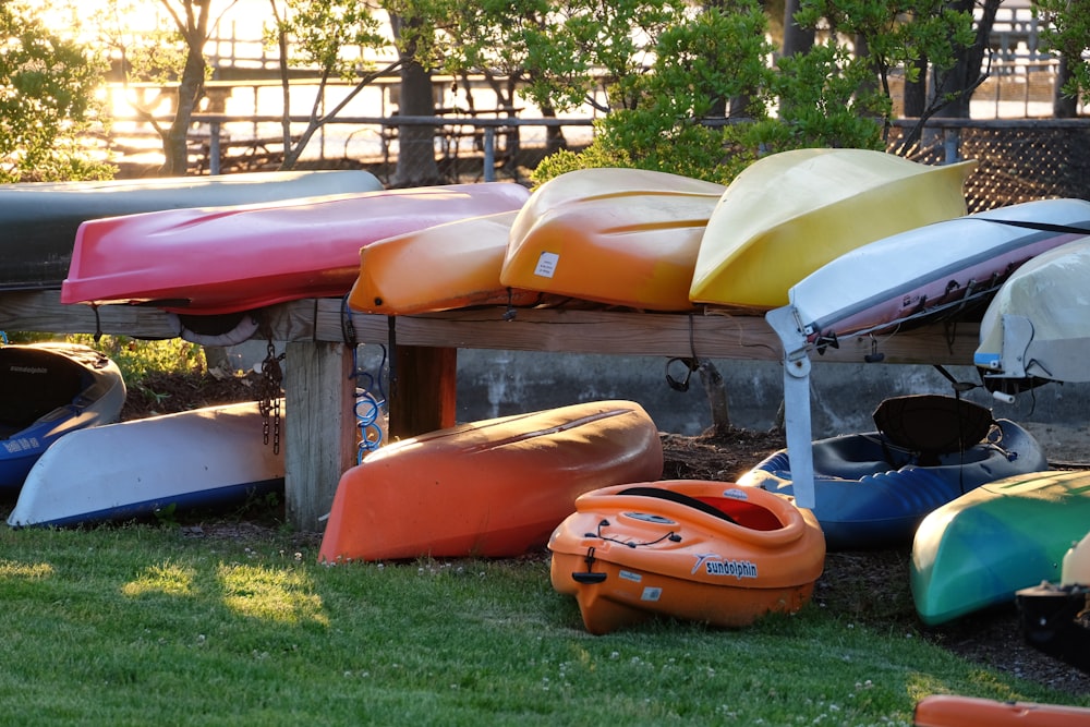 red and yellow kayak on green grass field