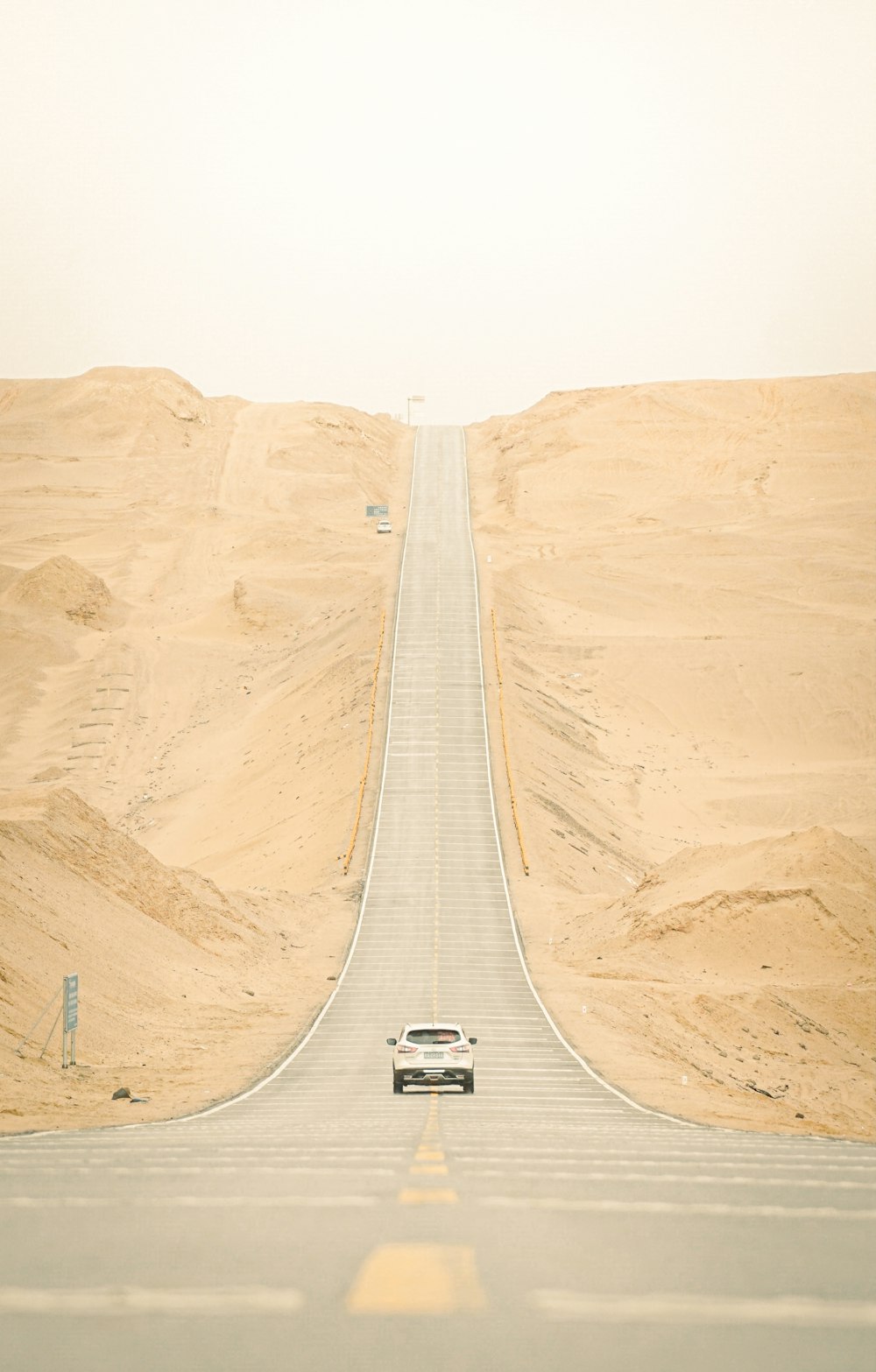 white car on gray asphalt road during daytime