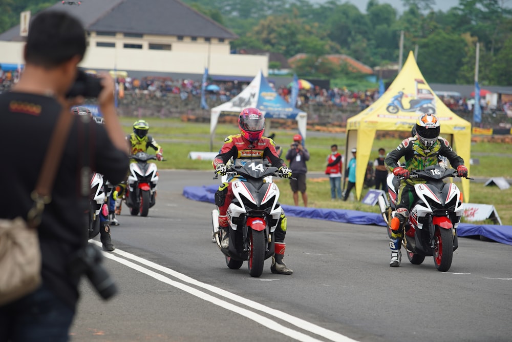 people riding motorcycle on road during daytime