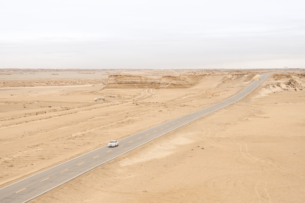 black car on brown sand