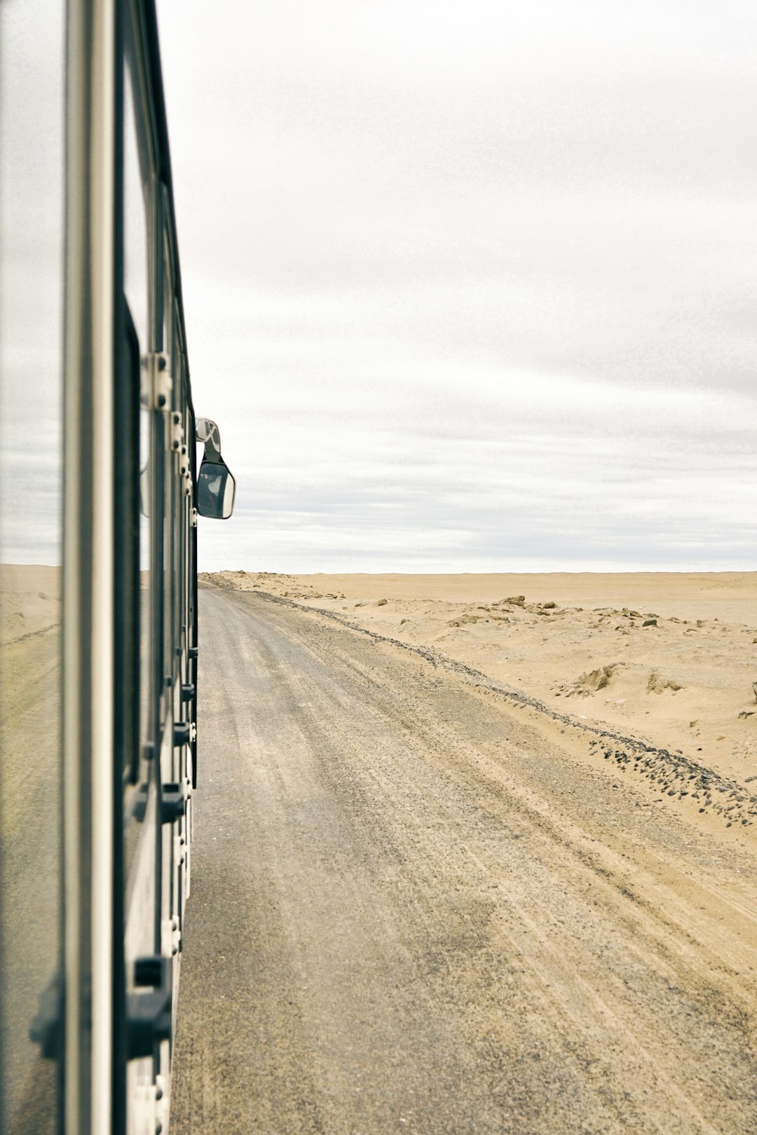 white car on brown sand during daytime