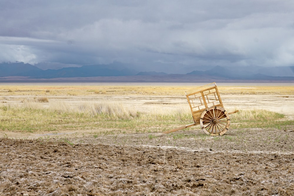 brown wooden chair on brown field during daytime