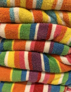 a stack of multicolored towels sitting on top of each other