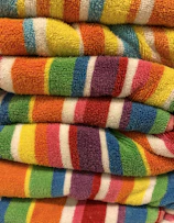 a stack of multicolored towels sitting on top of each other