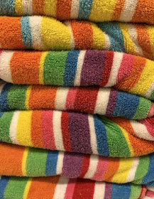 a stack of multicolored towels sitting on top of each other
