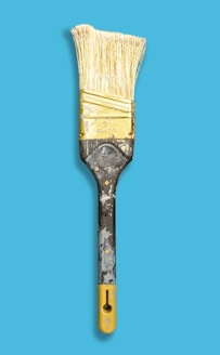 brown paint brush with blue background