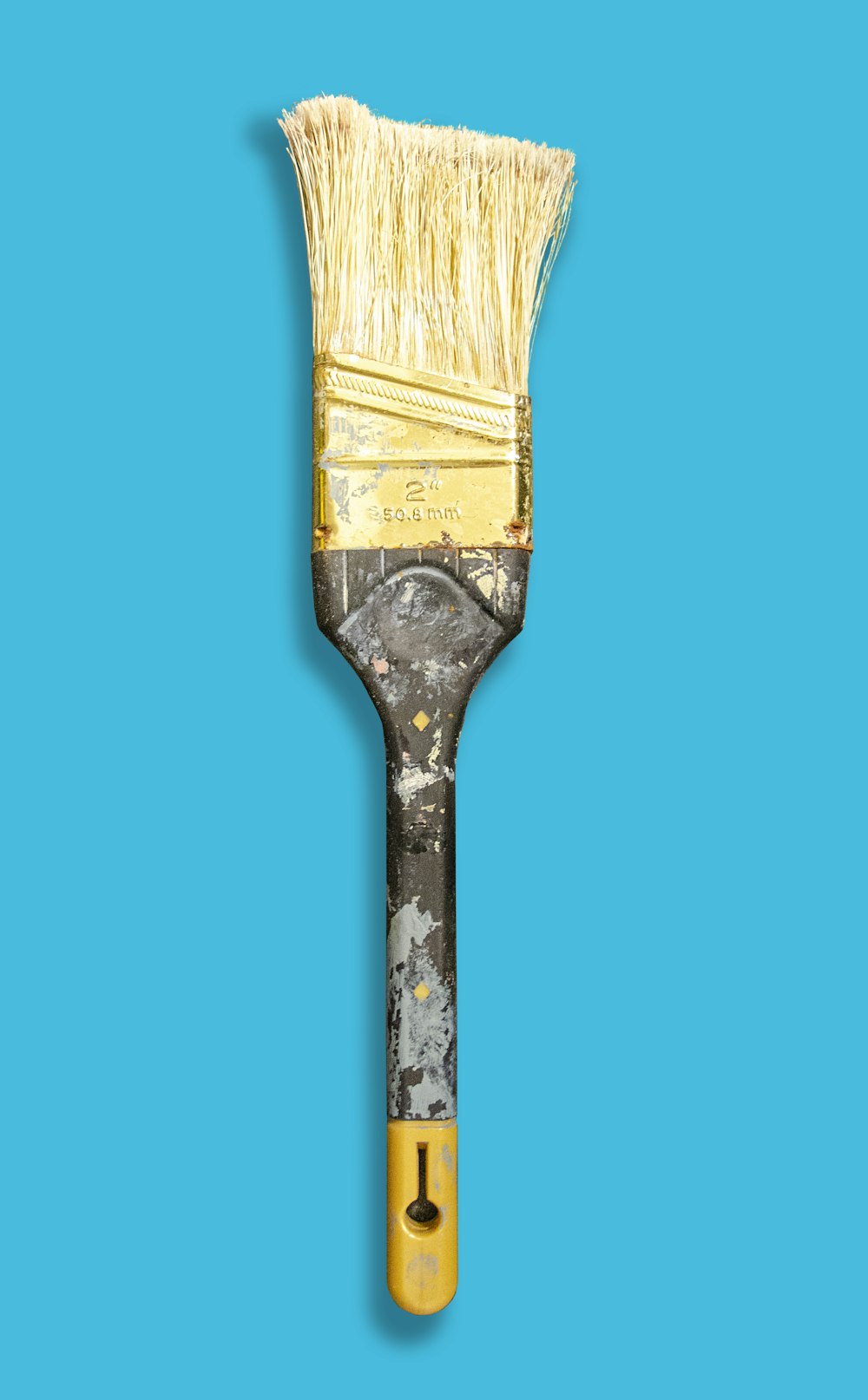 brown paint brush with blue background