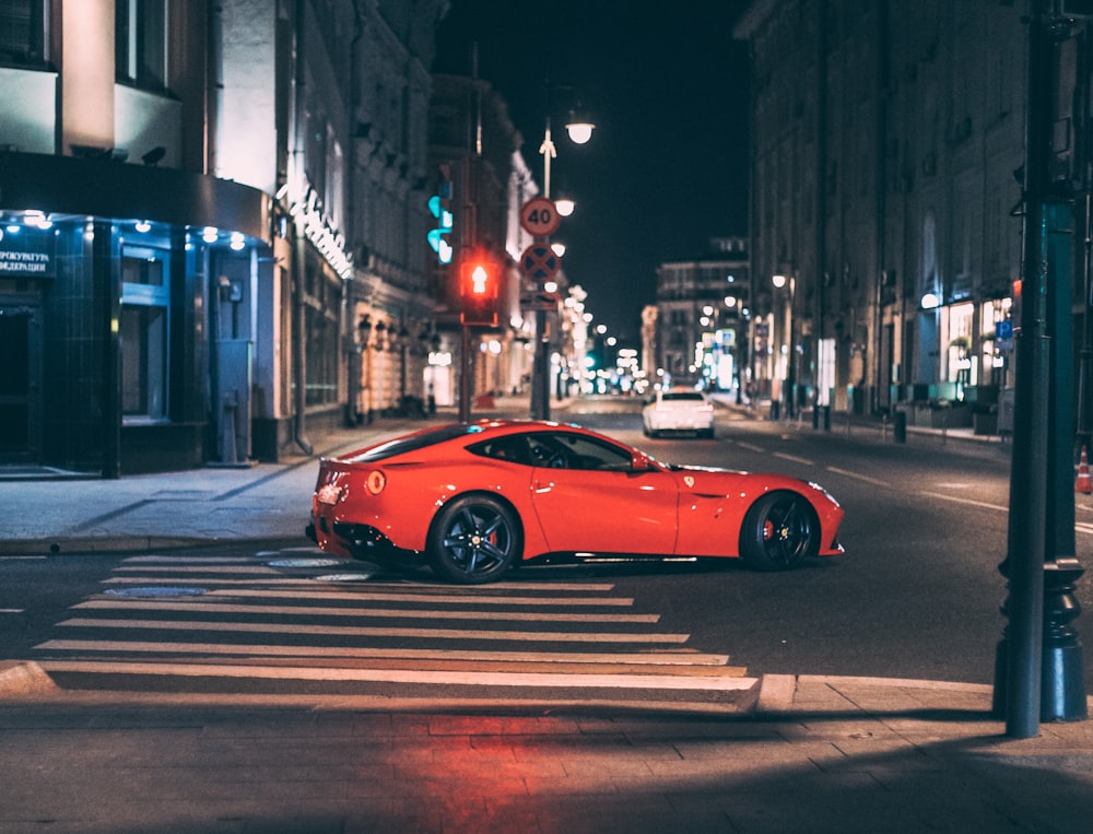 red ferrari 458 italia on road during night time