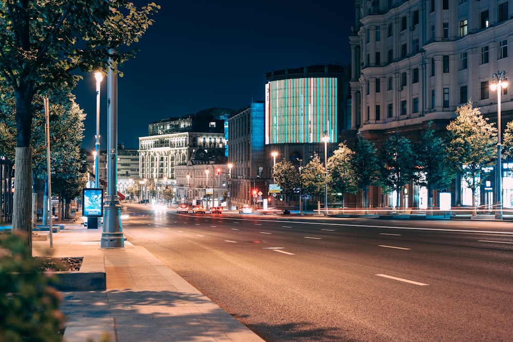 city buildings with lights turned on during night time