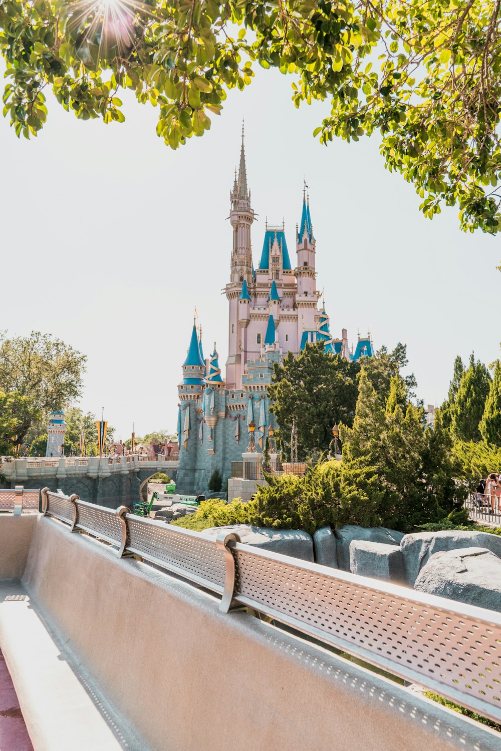 white and blue castle surrounded by green trees during daytime