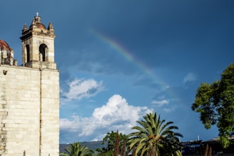 brown concrete tower with rainbow