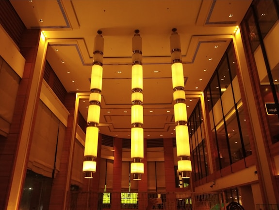 An overhead view of a sophisticated, timeless event space bathed in soft golden lighting.