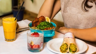 person holding green vegetable on white ceramic plate