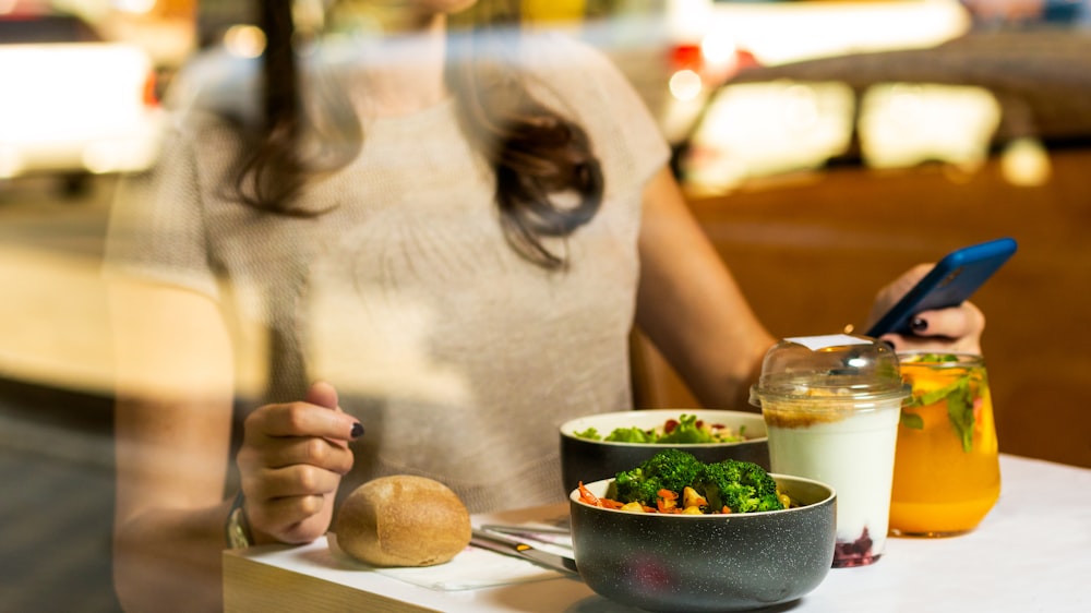 woman in white tank top holding spoon