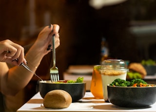 person holding silver fork and knife