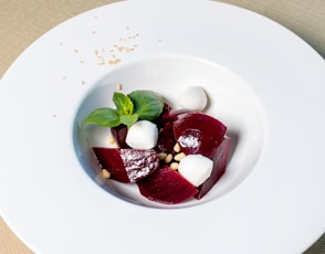 red and white sliced fruits on white ceramic plate