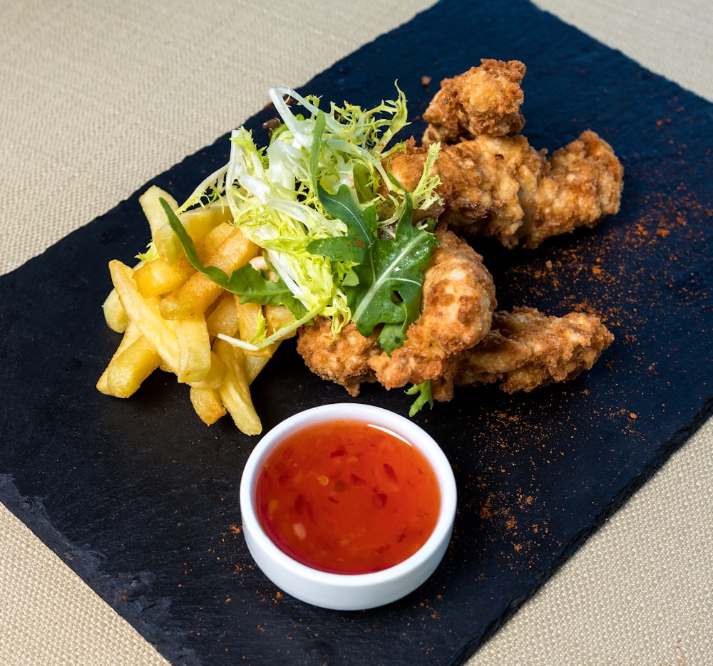 fried chicken and fries on blue ceramic plate