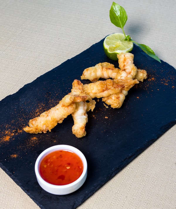Fried chicken on black rectangular plate