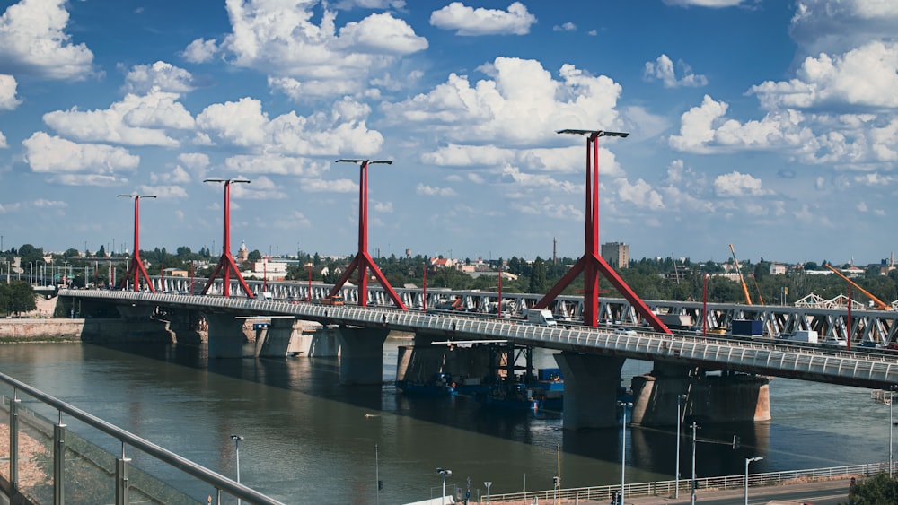 red and white bridge under cloudy sky during daytime