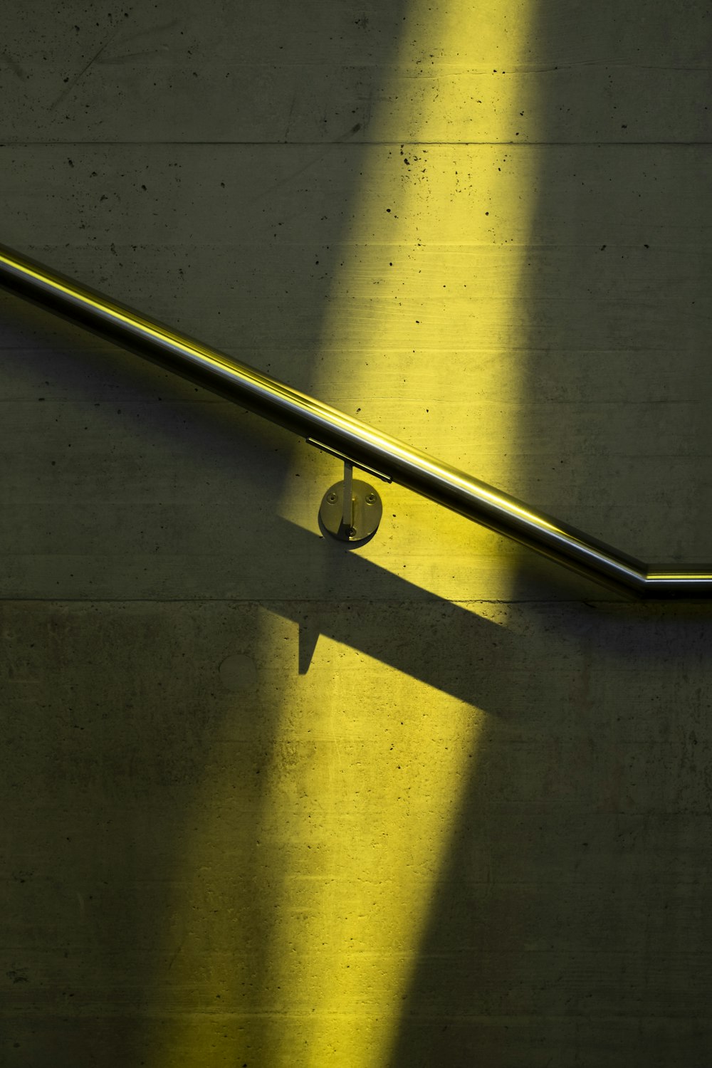 stainless steel railings on yellow and white painted wall