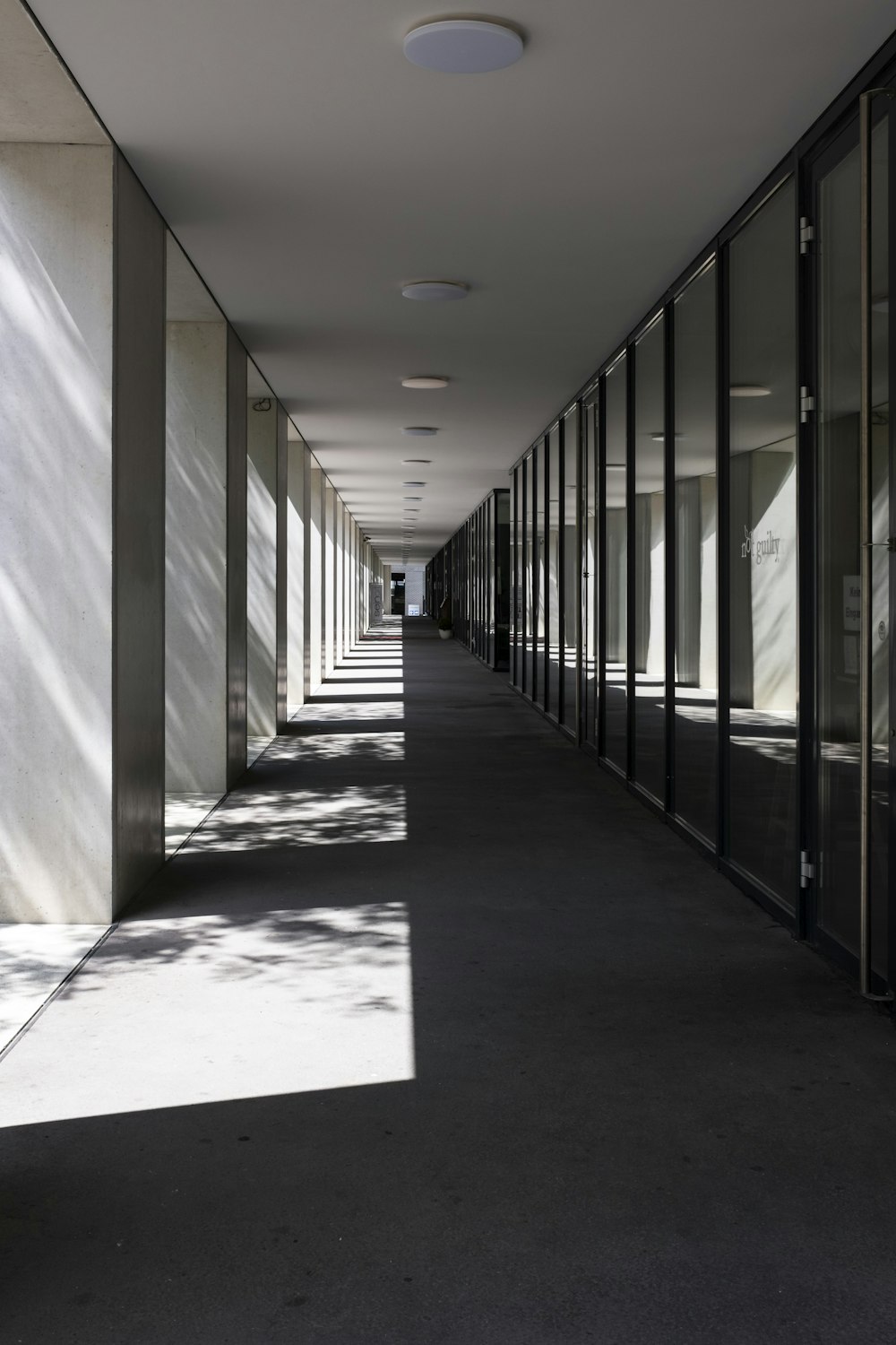 white hallway with black metal railings