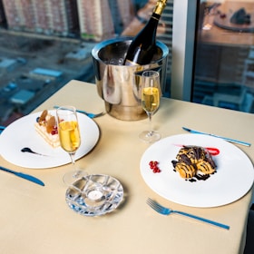 An elegant table set with caviar, champagne, and fine dining elements.