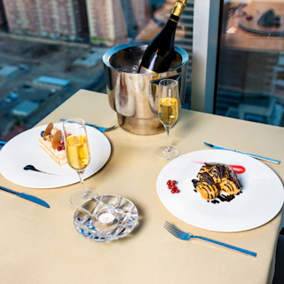 Close-up of a sophisticated table setting with a small charcuterie board and sparkling wine