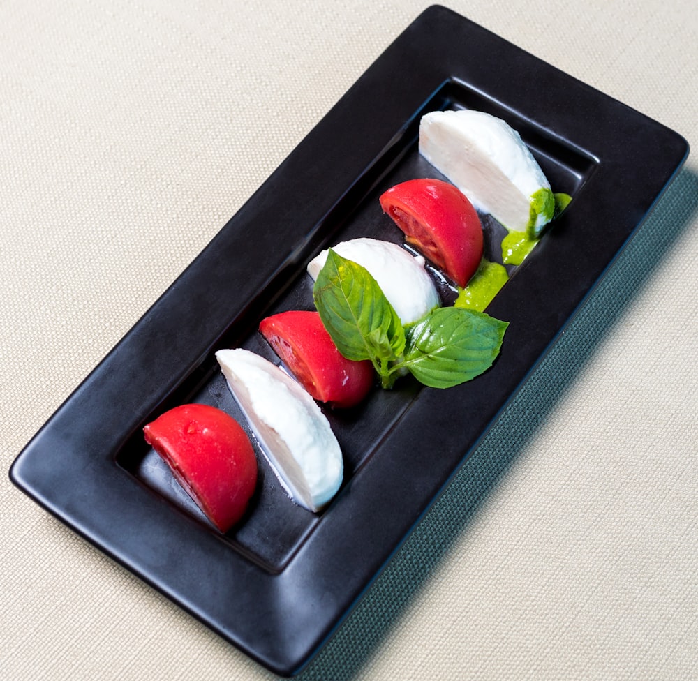 white and red ice cream on black rectangular tray
