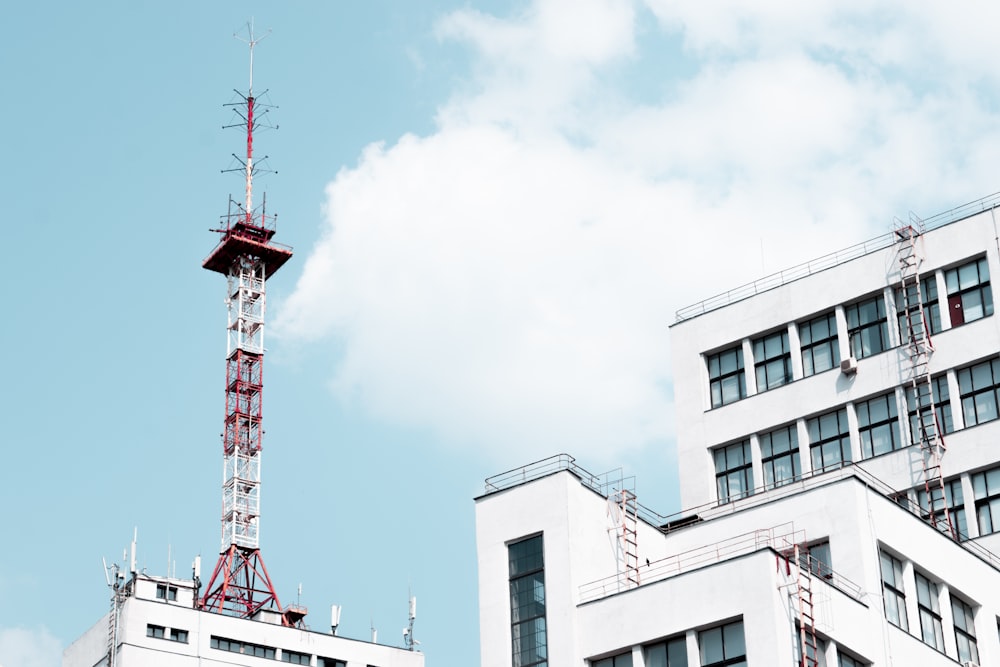 white concrete building with red tower