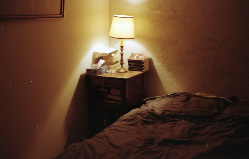 white table lamp on brown wooden nightstand