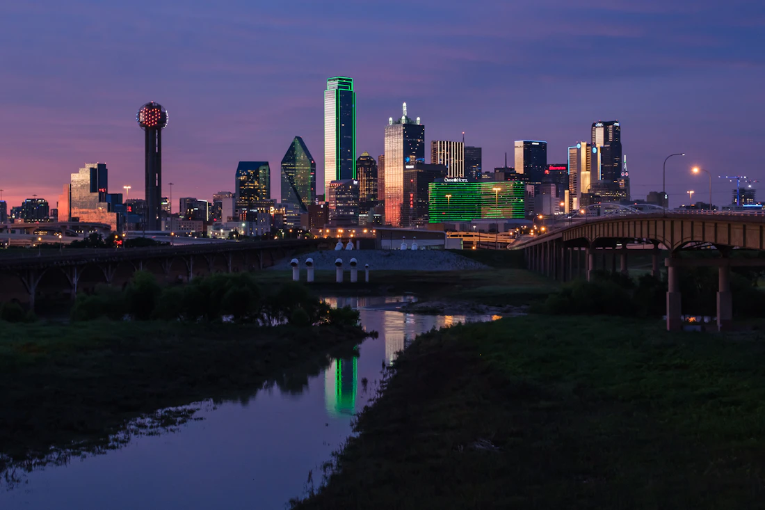 Uptown Dallas — high-rise skyline lit up at dusk
