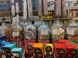 Italian food products displayed on shelves in a busy Eastern European supermarket.