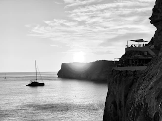 grayscale photo of sailboat on sea