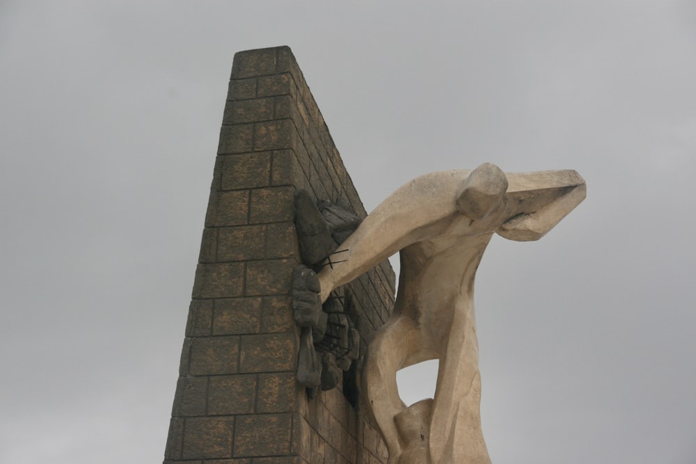 brown concrete statue under blue sky during daytime