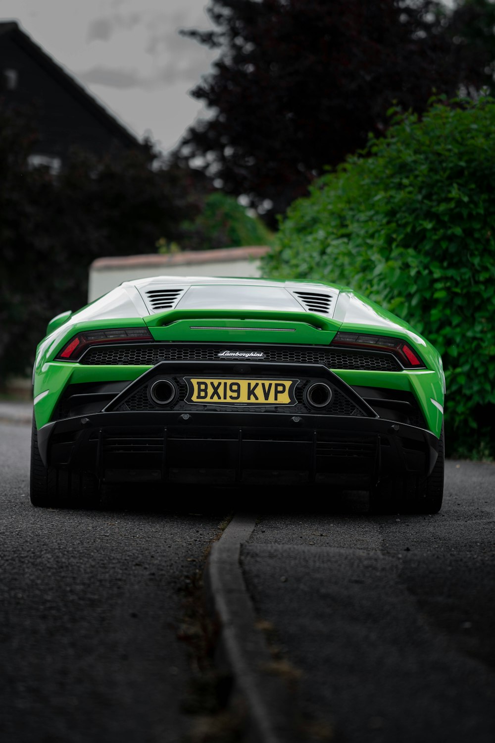 green and black porsche 911 on road during daytime