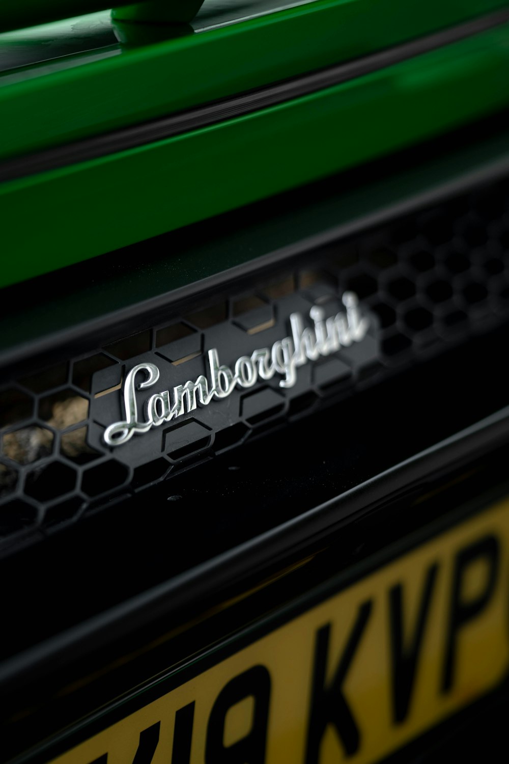the emblem on the front of a green vehicle