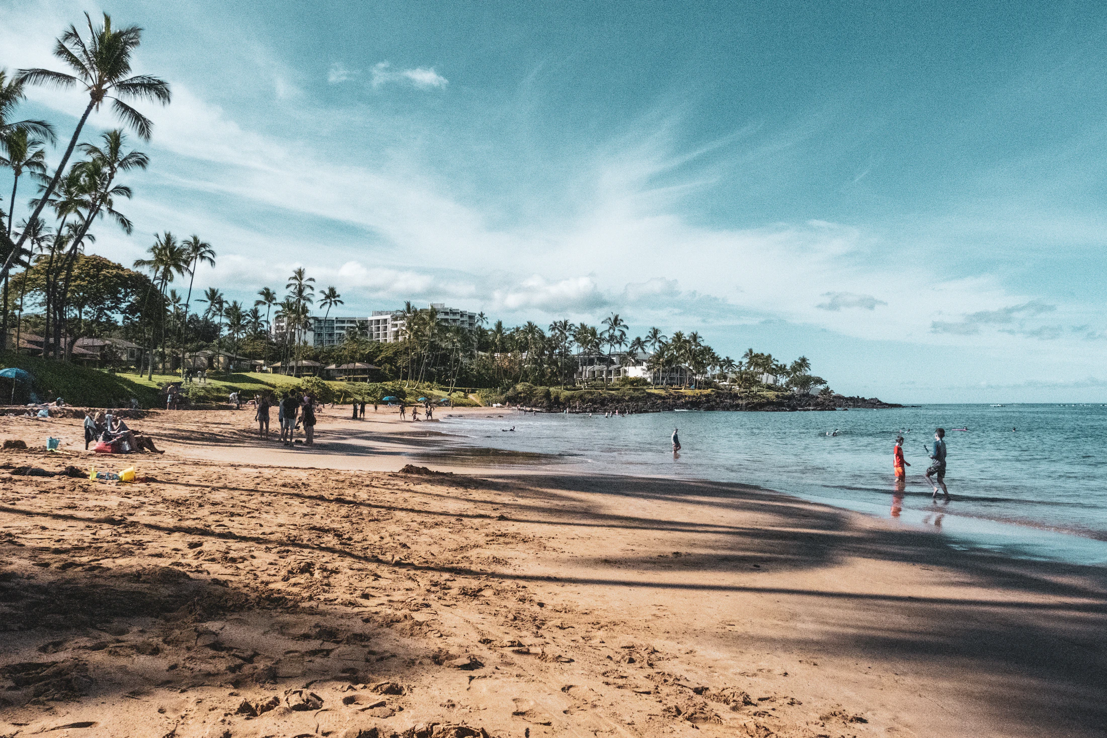 Swimmers and beachgoers at Wailea Beach in South Maui