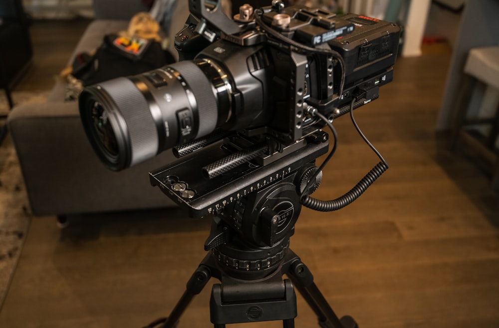 black dslr camera on brown wooden table