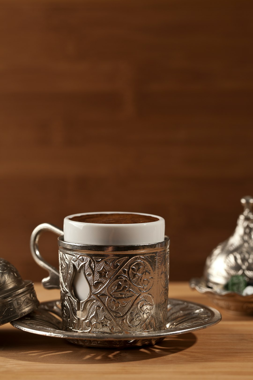 white and black floral ceramic mug on table