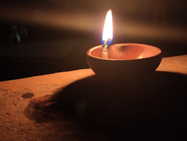 A peaceful evening scene with soft cushions and a glowing lamp, inviting a sense of comfort and calm.