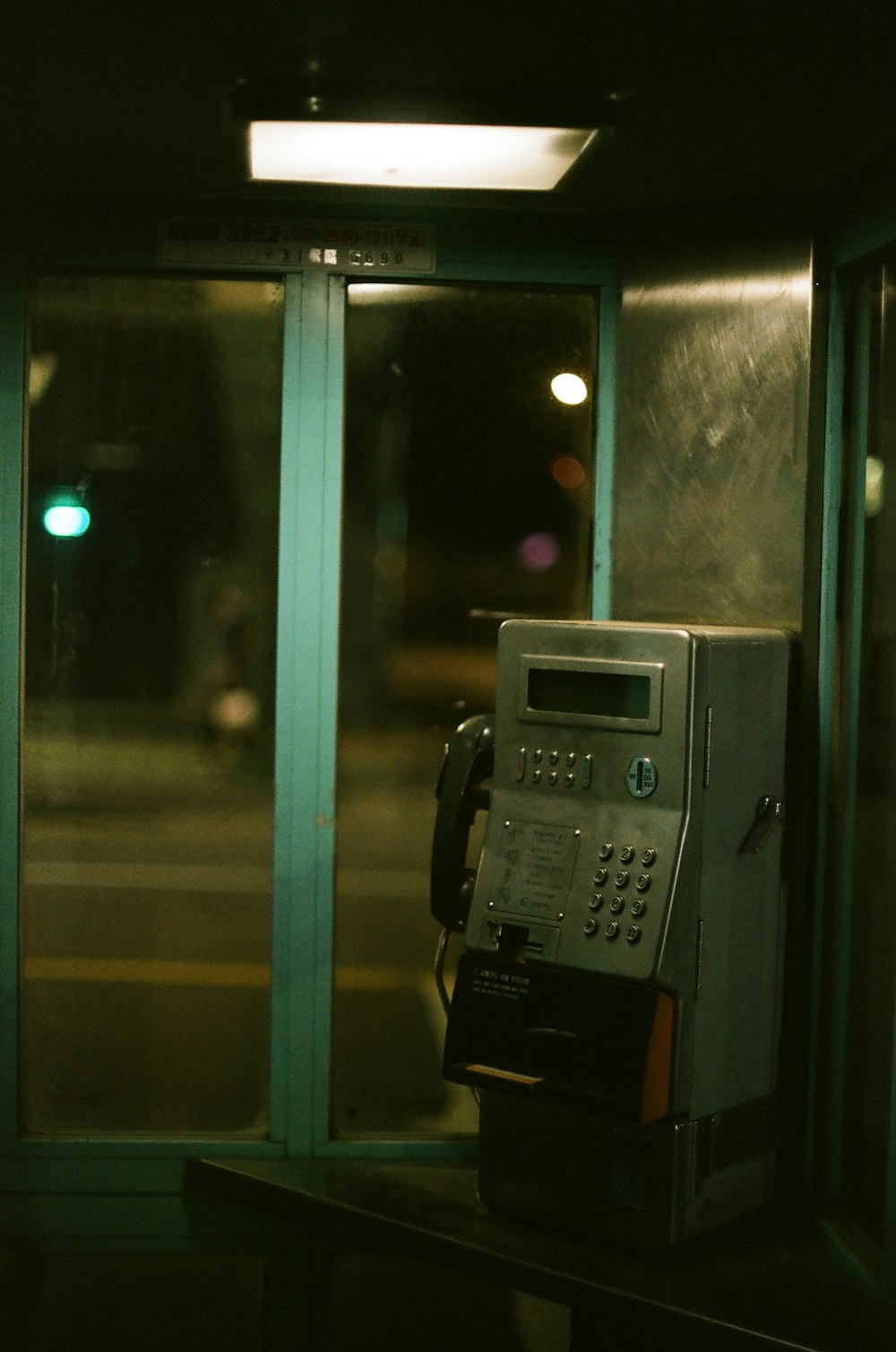 black telephone booth during night time
