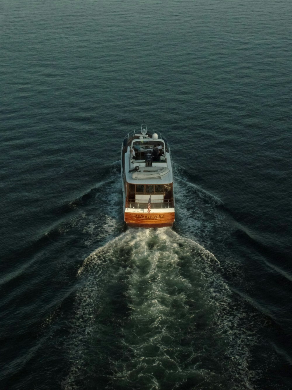 white and brown boat on body of water during daytime