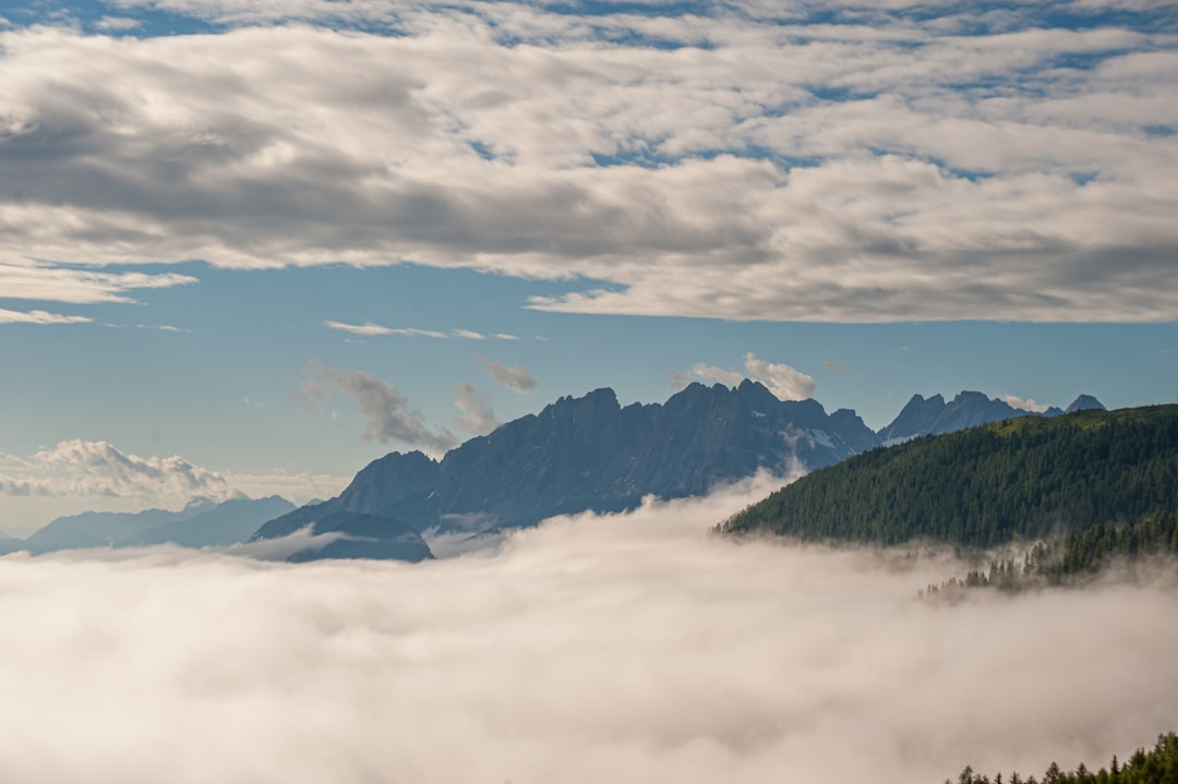 green mountains under white clouds and blue sky during daytime