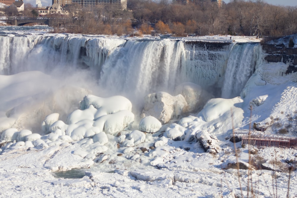 white ice on water falls during daytime