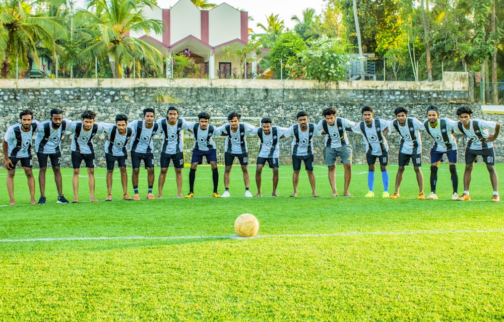 soccer players on green grass field during daytime