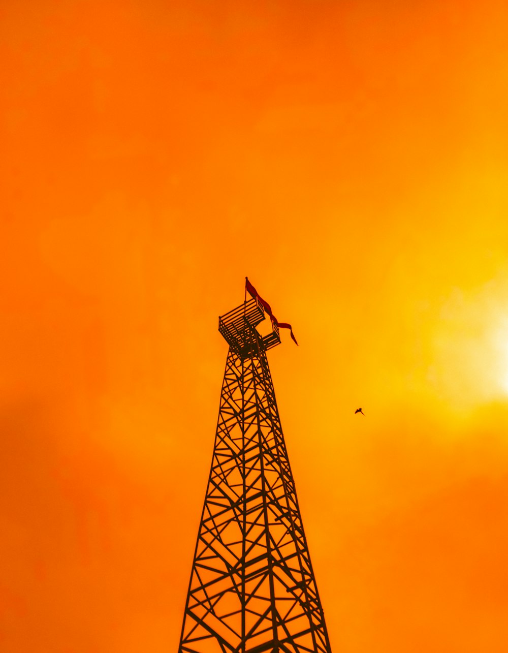 silhouette of tower under orange sky