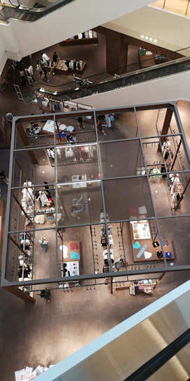 A bustling multi-level pet mall filled with happy pets and their owners exploring various themed floors.