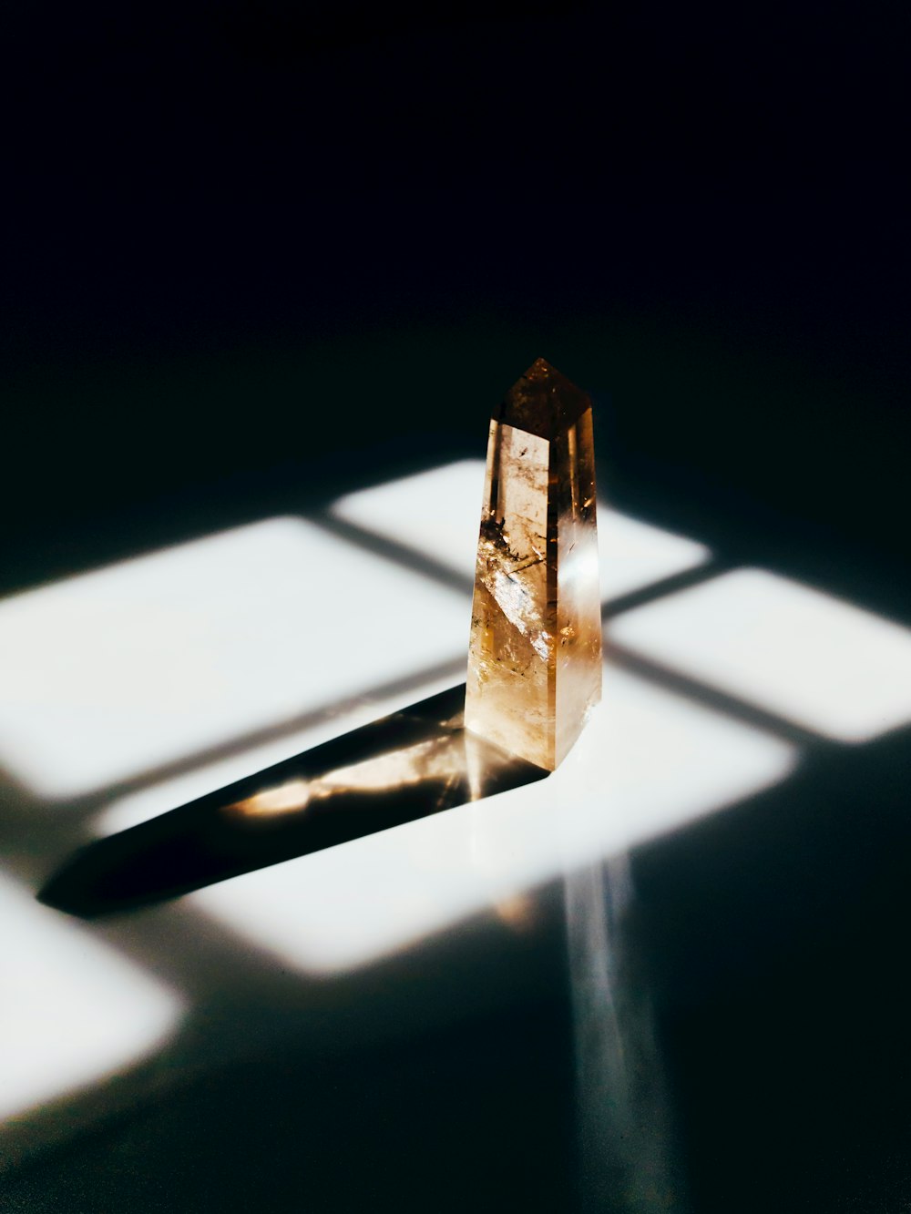 gold and silver pendant on white surface