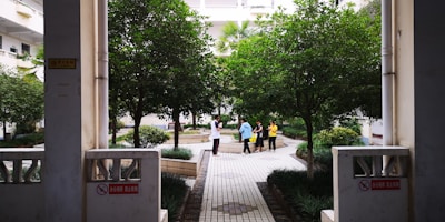 An inviting courtyard filled with flowers and people engaging in conversation.