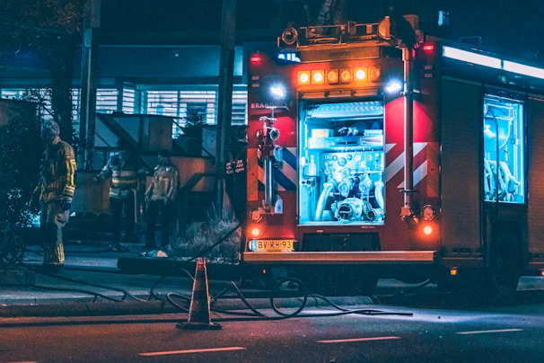 Volunteers loading equipment into a rescue vehicle under the soft glow of evening light.